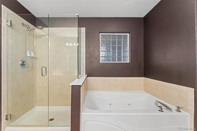 a bathroom with a bathtub and a shower