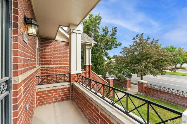a view of balcony with wooden floor and fence