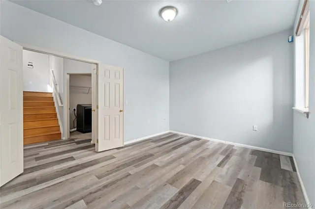 a view of a livingroom with wooden floor and window