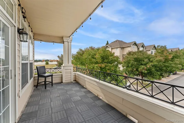 a view of a balcony with chairs and a table