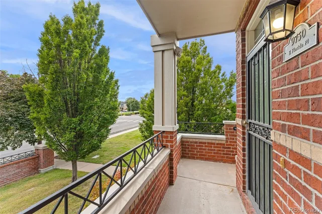 a view of balcony with wooden floor and fence