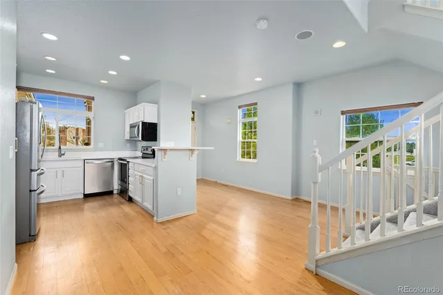 a view of a kitchen with a sink cabinets and wooden floor