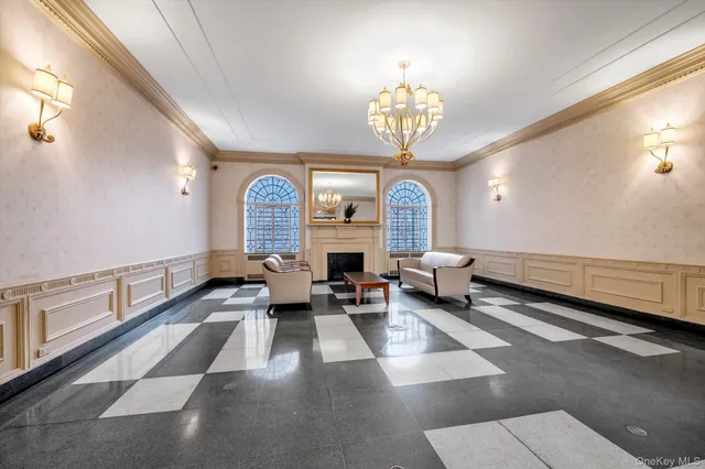 a living room with fireplace furniture and a chandelier