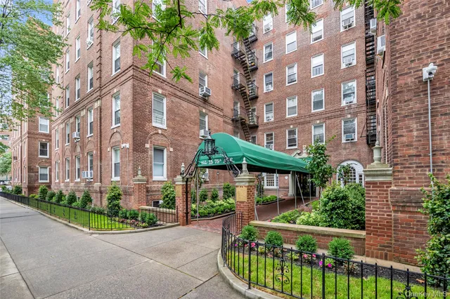 a view of a brick building next to a yard
