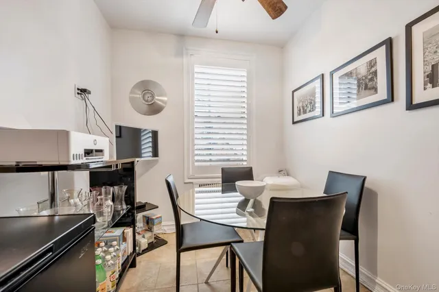 a view of a dining room with furniture and a window