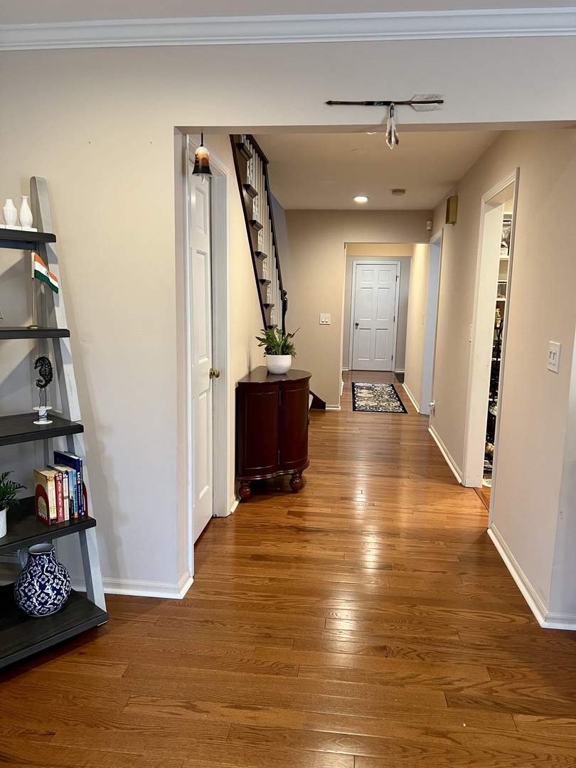 815 Suffield Square Lincolnshire, IL 60069 - Photo 12 of 27 a view of a hallway with wooden floor and staircase