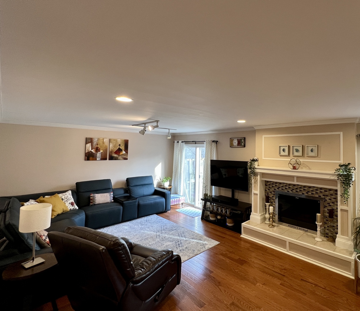 815 Suffield Square Lincolnshire, IL 60069 - Photo 2 of 27 a living room with furniture a fireplace and a flat screen tv