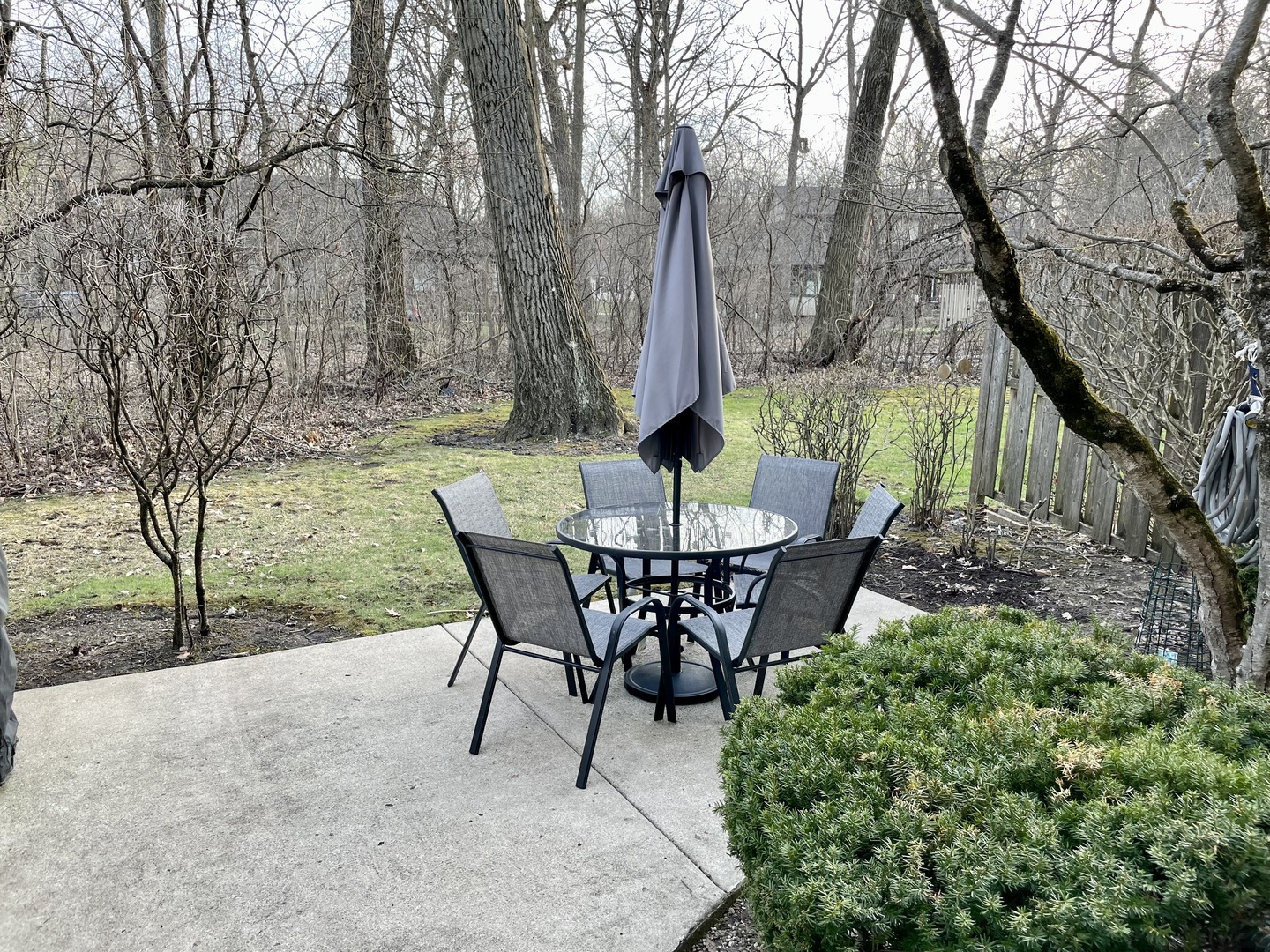 815 Suffield Square Lincolnshire, IL 60069 - Photo 26 of 27 a view of a backyard with table and chairs and a fire pit
