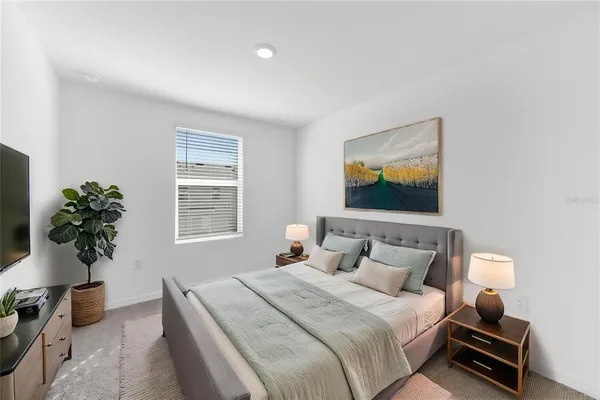 a bedroom with a large bed and a window