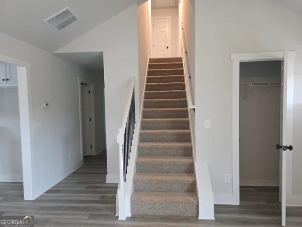 a view of an entryway with wooden floor
