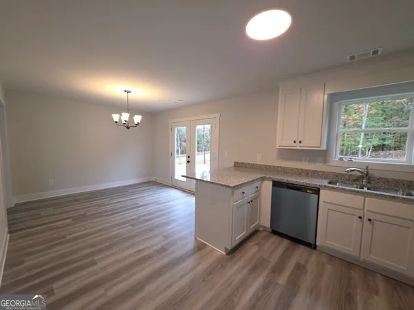 a kitchen with a sink cabinets and window
