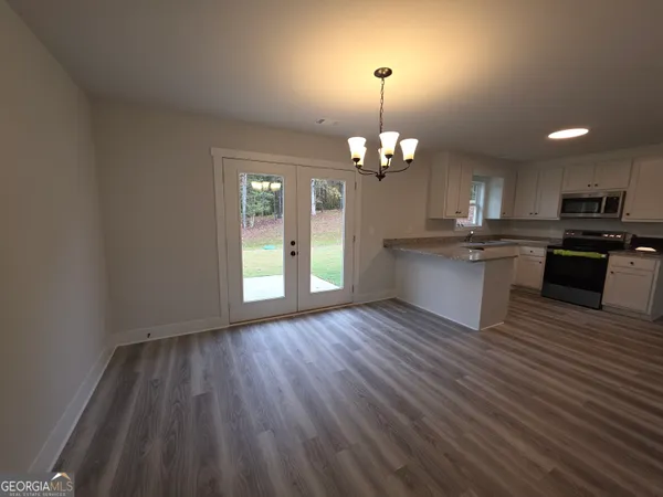 a view of a kitchen with sink and cabinets