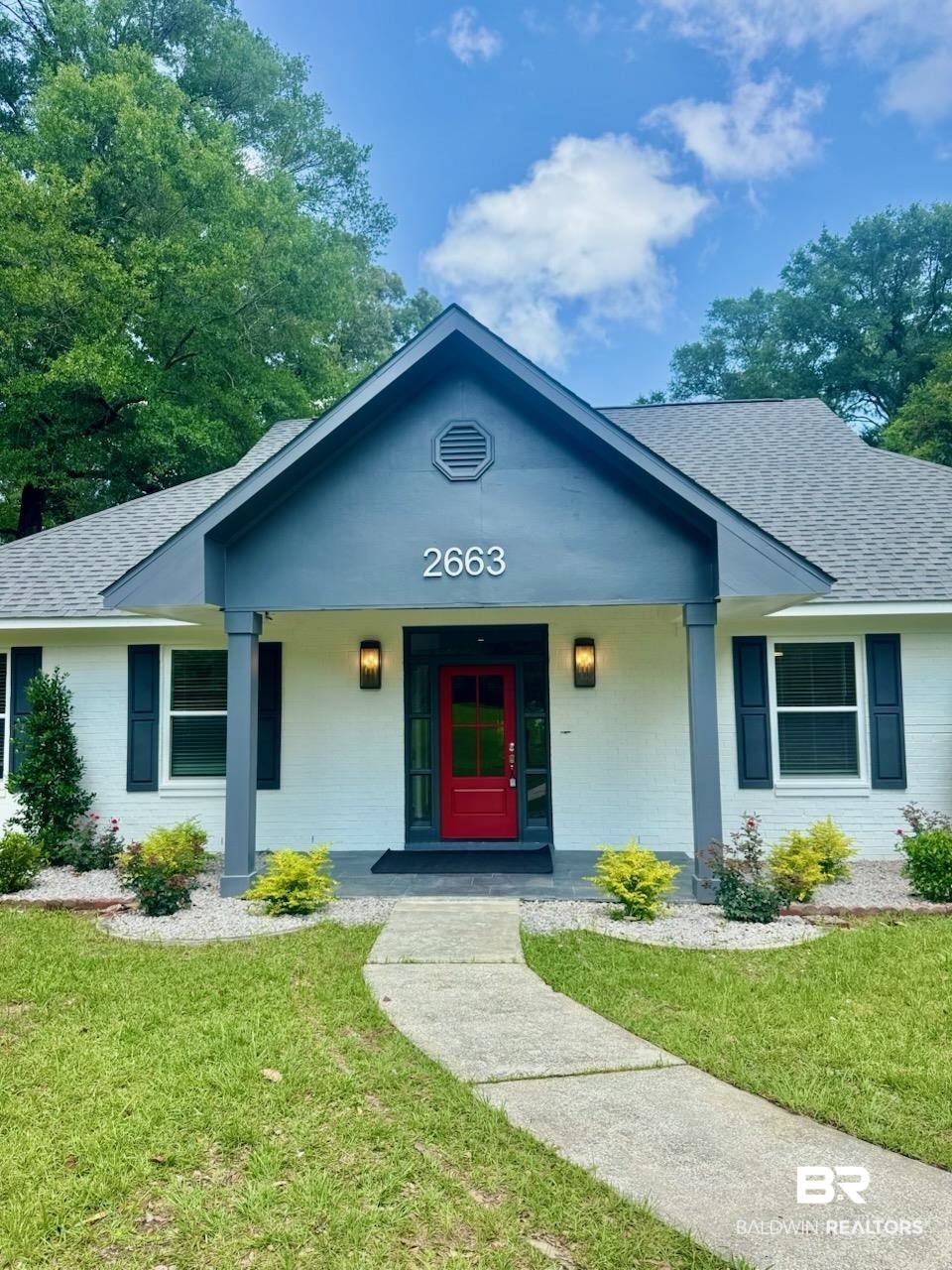 2663 Demetropolis Road Mobile, AL 36693 - Photo 3 of 26 View of front of property with a shingled roof, a front yard, and covered porch