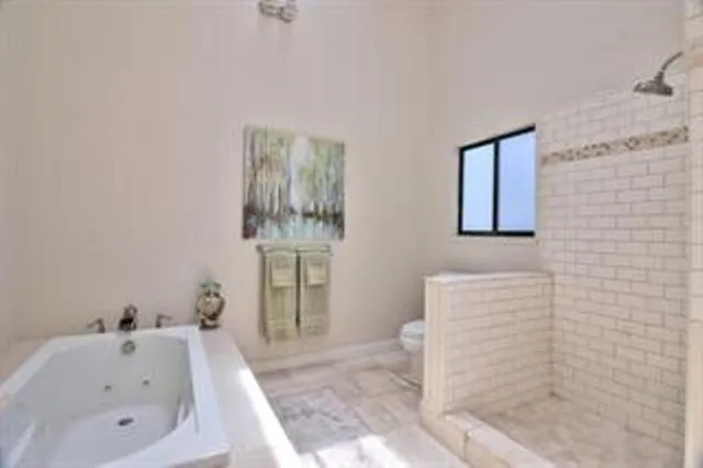 a bathroom with a tub sink and mirror