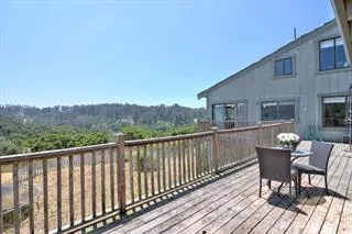 a balcony with wooden floor and fence