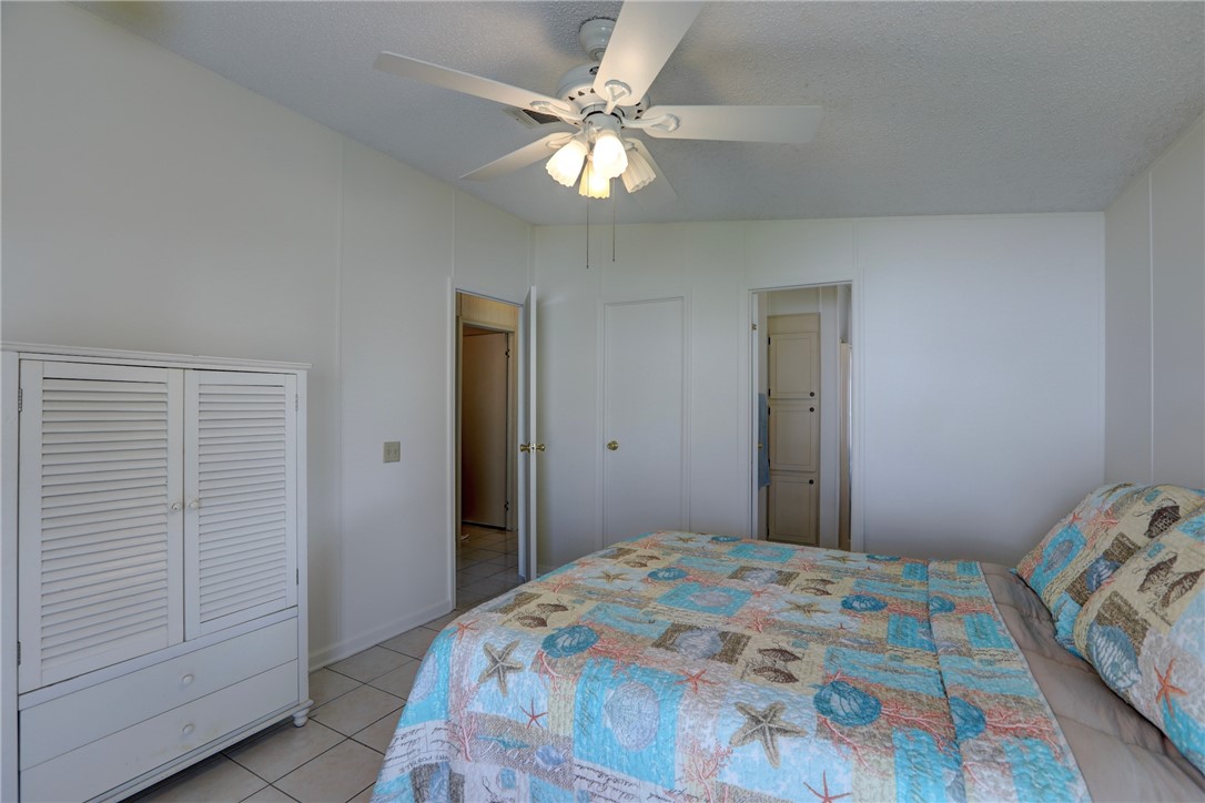 818 Tamarind Circle Sebastian, FL 32976 - Photo 13 of 31 a bedroom with a bed and a chandelier