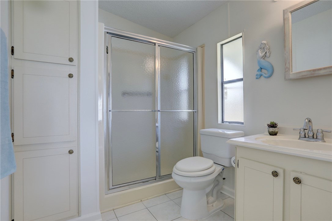 818 Tamarind Circle Sebastian, FL 32976 - Photo 14 of 31 a bathroom with a sink a toilet and shower
