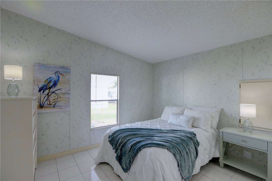 818 Tamarind Circle Sebastian, FL 32976 - Photo 15 of 31 a bedroom with a bed and a window
