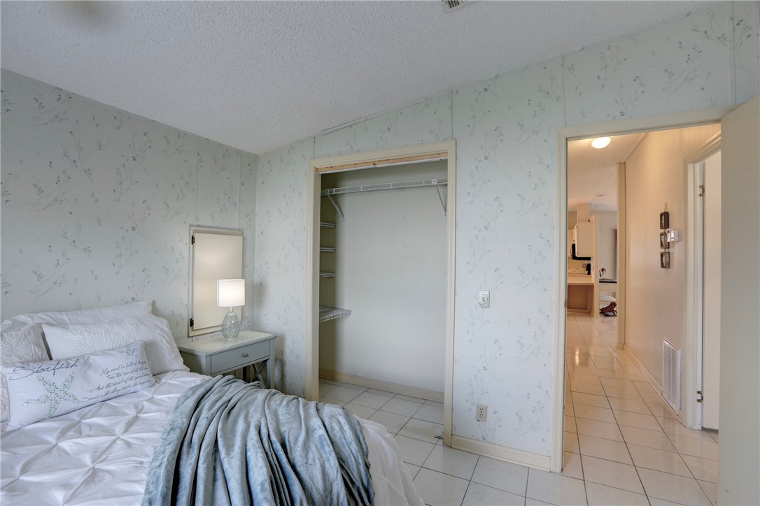 818 Tamarind Circle Sebastian, FL 32976 - Photo 16 of 31 a bedroom with a bed and a view of bathroom