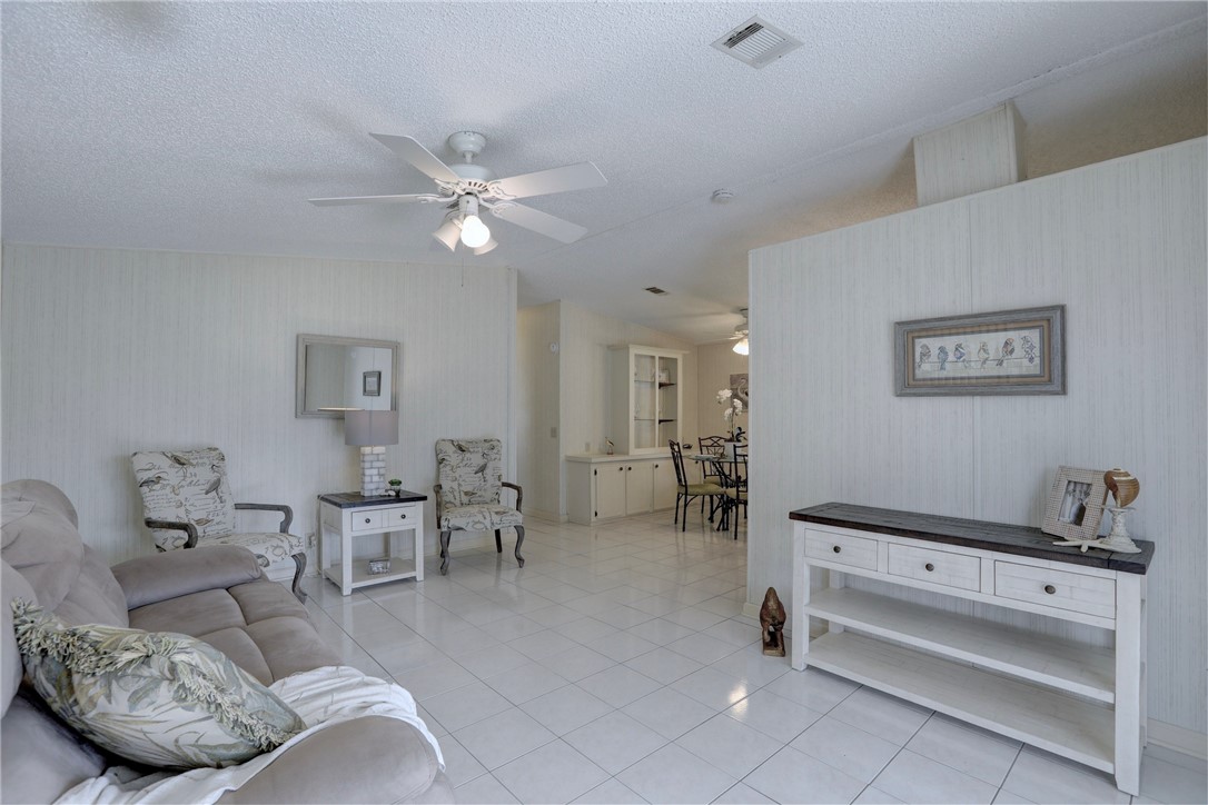 818 Tamarind Circle Sebastian, FL 32976 - Photo 3 of 31 a living room with furniture and a chandelier
