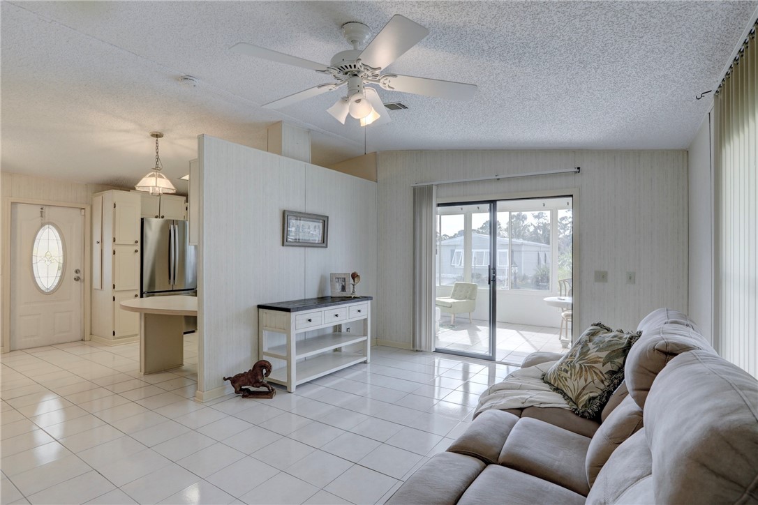 818 Tamarind Circle Sebastian, FL 32976 - Photo 4 of 31 a living room with furniture and a large window