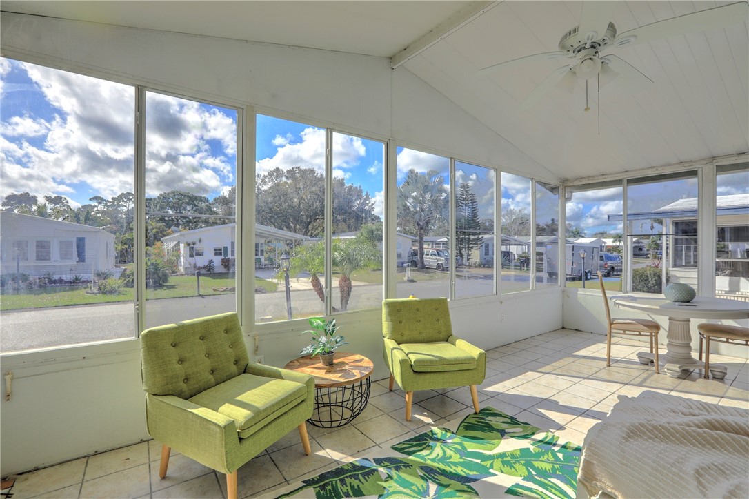 818 Tamarind Circle Sebastian, FL 32976 - Photo 6 of 31 a living room with furniture and a floor to ceiling window