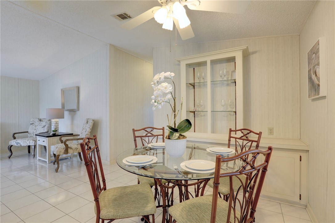 818 Tamarind Circle Sebastian, FL 32976 - Photo 8 of 31 a view of a dining room with furniture and chandelier