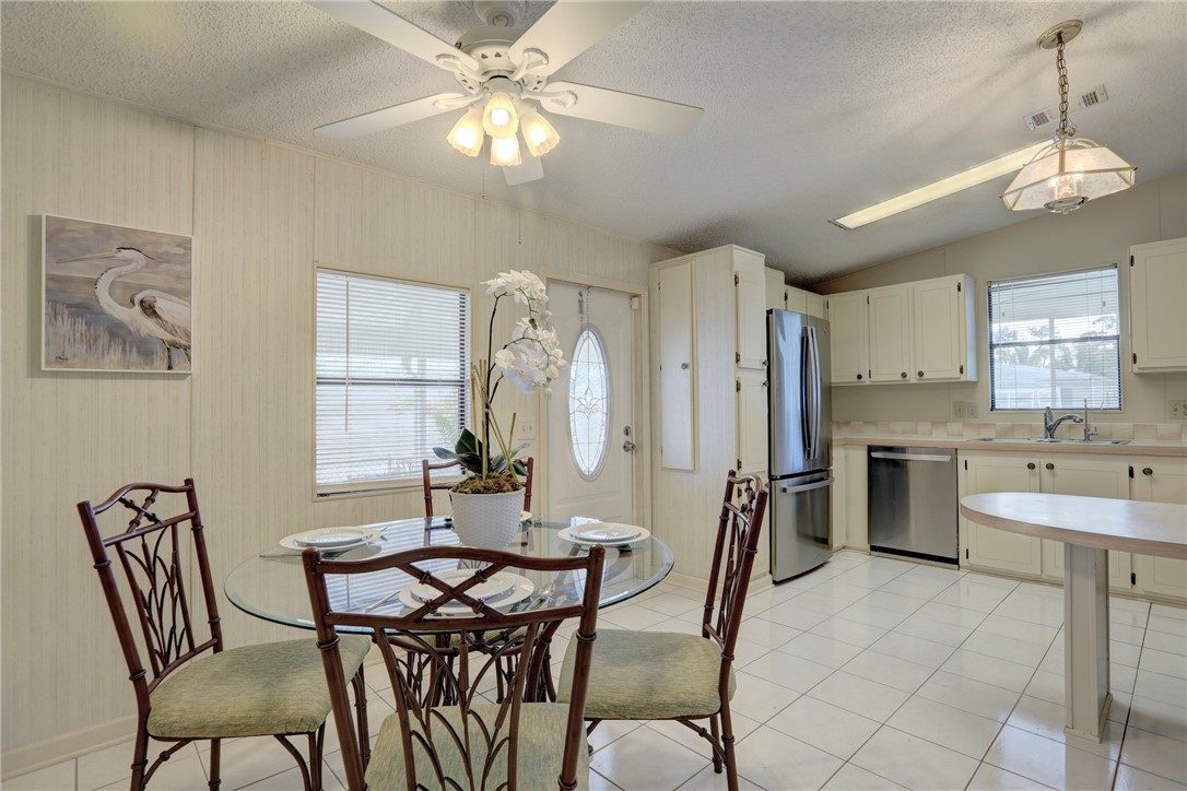 818 Tamarind Circle Sebastian, FL 32976 - Photo 9 of 31 a view of a dining room with furniture and a chandelier