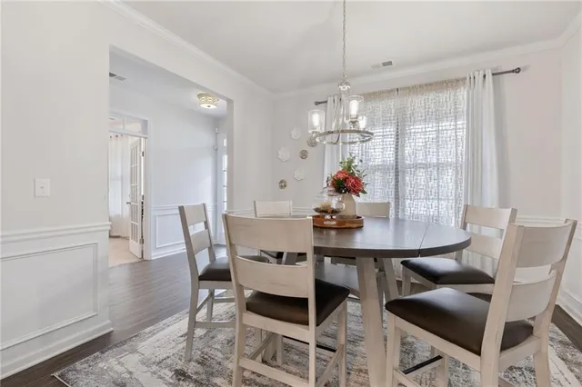a kitchen with sink stove and chairs