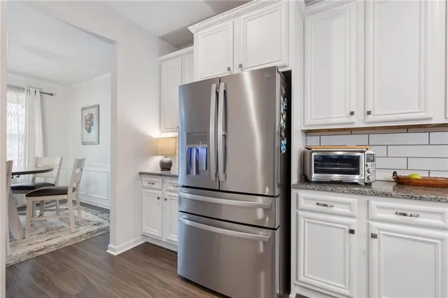 a view of a a dining room with furniture window and wooden floor