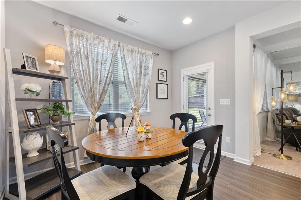 1718 Landon Lane Braselton, GA 30517 - Photo 17 of 52 a view of a a dining room with furniture window and wooden floor
