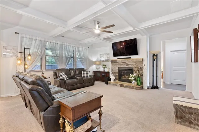 a living room with furniture and a chandelier