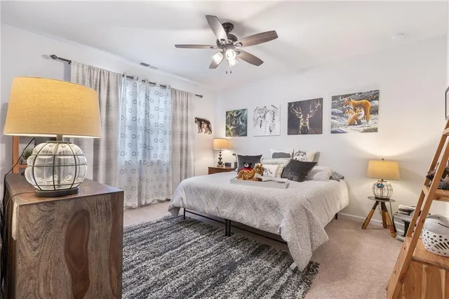 a bathroom with a granite countertop sink toilet and a mirror