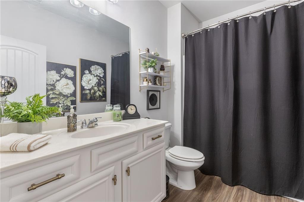 1718 Landon Lane Braselton, GA 30517 - Photo 22 of 52 a bathroom with a granite countertop sink toilet and a mirror
