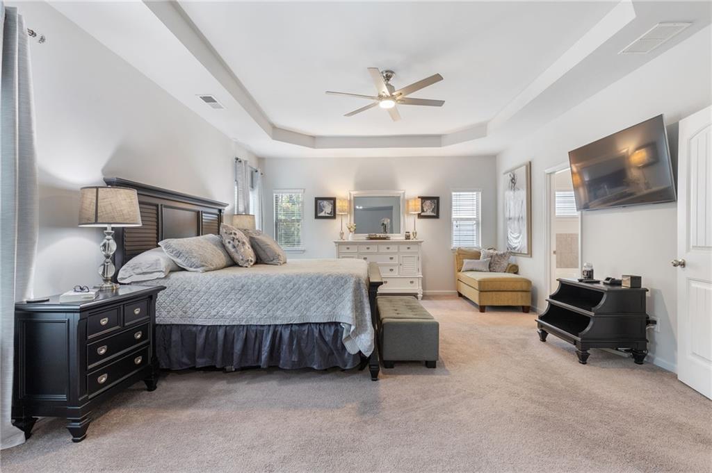 1718 Landon Lane Braselton, GA 30517 - Photo 26 of 52 a spacious bedroom with a bed and a flat screen tv