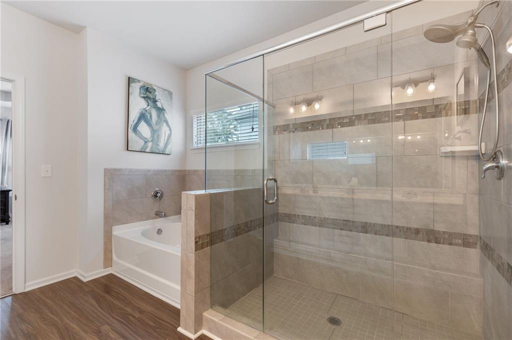 1718 Landon Lane Braselton, GA 30517 - Photo 31 of 52 a bathroom with a bathtub and shower