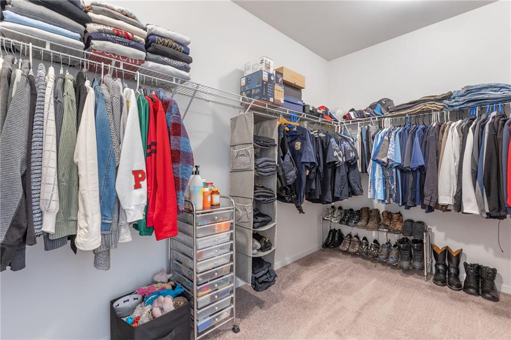1718 Landon Lane Braselton, GA 30517 - Photo 32 of 52 a view of walk in closet with clothes and shoes