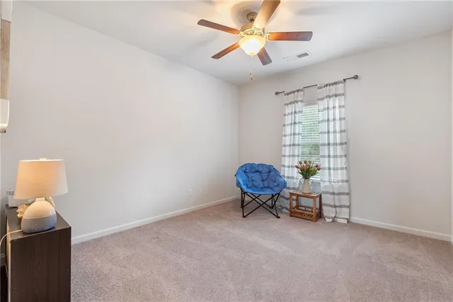 a view of a livingroom with furniture and a workspace
