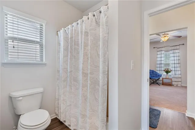 a living room with furniture a window and a flat screen tv