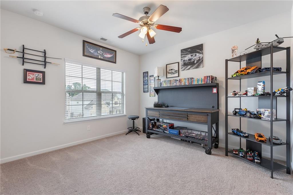 1718 Landon Lane Braselton, GA 30517 - Photo 39 of 52 a living room with furniture a window and a flat screen tv