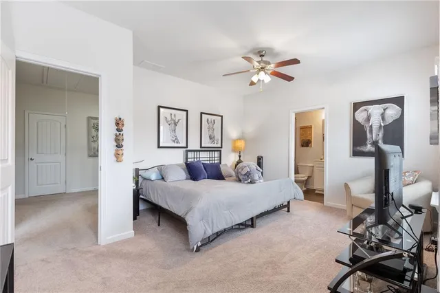 a bathroom with a sink a toilet a mirror and shower curtain