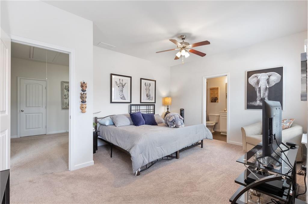 1718 Landon Lane Braselton, GA 30517 - Photo 41 of 52 a bedroom with a bed and a chandelier