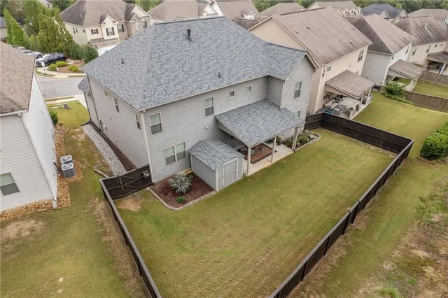 an aerial view of a house with a swimming pool