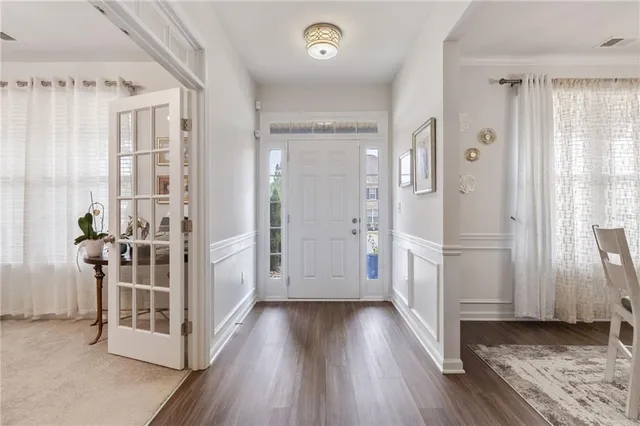 a view of a livingroom with wooden floor and furniture