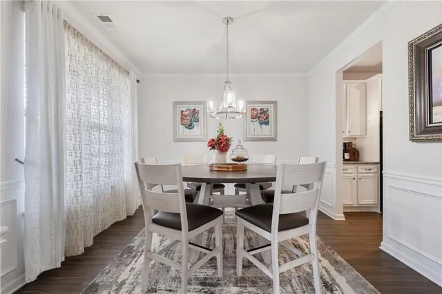 a view of a dining room with furniture and chandelier