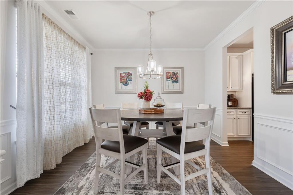 1718 Landon Lane Braselton, GA 30517 - Photo 10 of 52 a view of a dining room with furniture a rug and wooden floor