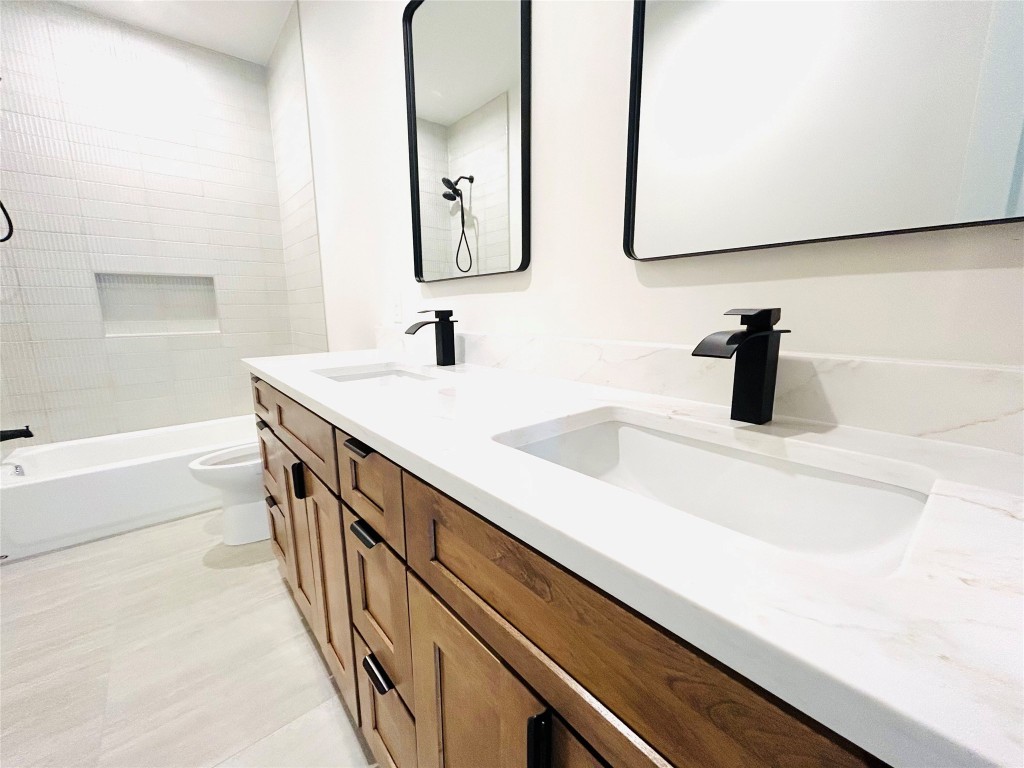 4324 Airport Boulevard, Unit B Austin, TX 78722 - Photo 15 of 22 a bathroom with a sink and a mirror