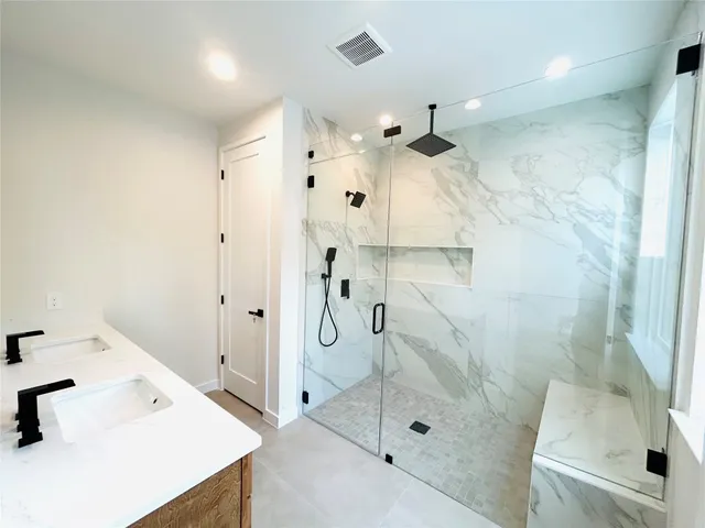 a bathroom with a sink a mirror and shower