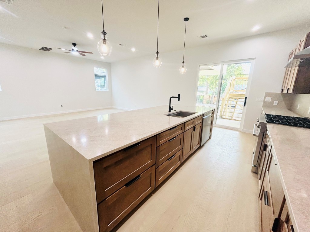 4324 Airport Boulevard, Unit B Austin, TX 78722 - Photo 7 of 22 a kitchen with stainless steel appliances granite countertop a sink a stove and a refrigerator