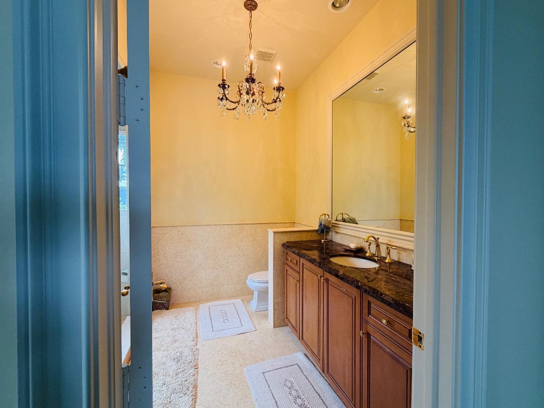 17730 Scarsdale Way Boca Raton, FL 33496 - Photo 27 of 42 a bathroom with a granite countertop sink a mirror and a shower